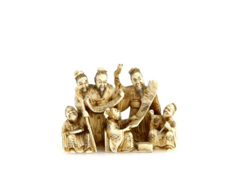 A stained ivory netsuke or small okimono carved as Seven Scholars reviewing two makemono, signed GyokuminProvenance: The Prop