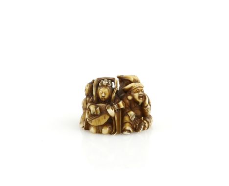 A stained ivory netsuke carved as four seated characters, presumably from The Shichifukujin, signed RakuminProvenance: The Pr