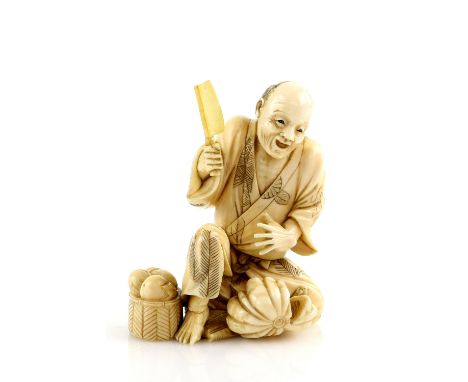 A stained ivory okimono, carved as a seated street vendor slicing a fruit, signed Kogetsu, 9 cm high, Meiji PeriodProvenance