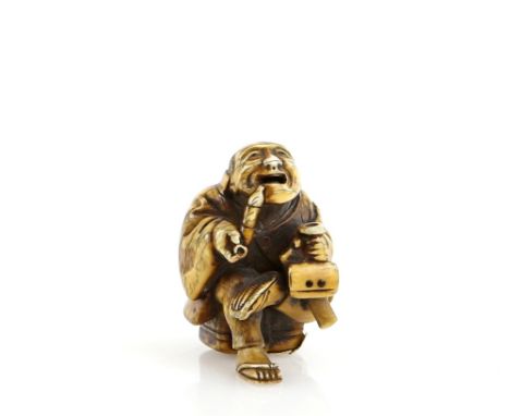 A stained ivory netsuke of a seated man, smoking a pipe whilst holding a sagemono in his left hand, signed ShogyokusaiProvena