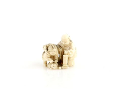 An ivory netsuke carved as an old man beside a boy with a puppy and parasol, 19th CenturyProvenance: The Property of a Lady. 