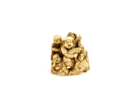 A small okimono carved as The Shichifukujin, including Daikoku with a fan and the Lucky Mallet; signed Ikkosai, 19th or 20th 