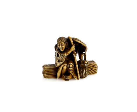 A stained ivory netsuke of the Heian waka poetess, Ono no Komachi  (circa 825-900),  seated on a log in old age as a metaphor