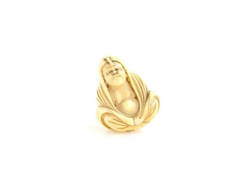 A Narwhal tusk netsuke of the Bodhisattva Daruma, wearing his typical loose fitting robes during the nine year mediation, sig