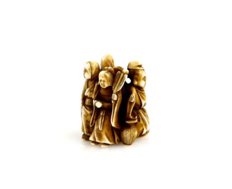 A stained ivory netsuke carved as five figures in a circle, 19th or 20th CenturyProvenance: The Property of a Lady. From a Pr