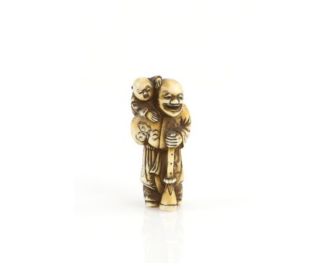 An ivory netsuke of a Dutchman, or other Gaijin, holding a long horn and carrying a child, signed MasatsuguProvenance: The Pr