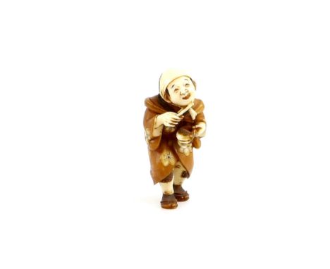 A stained ivory netsuke of a standing pilgrim beating a suzu, signed ShuzanProvenance: The Property of a Lady. From a Private