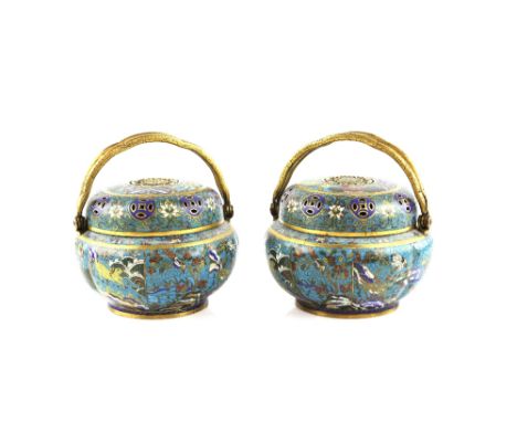 An elegant pair of Chinese cloisonne enamel incense burners; each one with hinged gilt handles, and of ribbed oviform design 