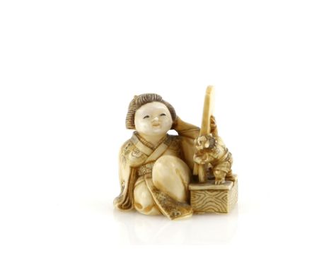 A stained ivory netsuke of Okame looking at a mirror held up by an Oni, signed...zanProvenance: The Property of a Lady. From 