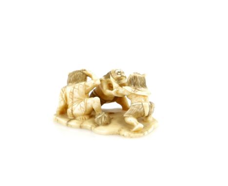 A large ivory netsuke with central himotoshi, carved as three Oni fighting, about 5 cm wide, 19th or 20th CenturyProvenance: 