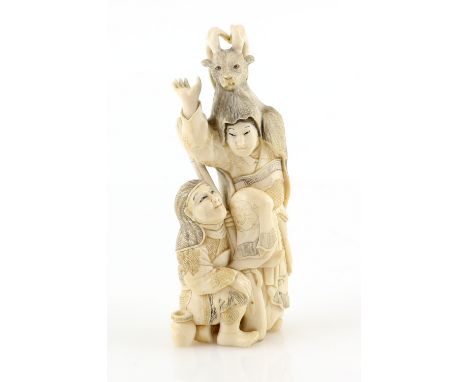 An ivory okimono carved as a seated hunter with a teppo beside a standing boy wearing a stag head dress, 12 cm high,  20th Ce