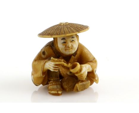 A stained ivory netsuke of a man, wearing a jingasa and holding a pipe with his right hand, signed ShuzanProvenance: The Prop