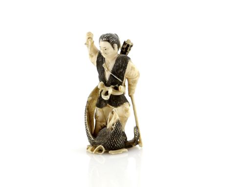 A heavily stained netsuke or small okimono carved as a man carrying a bow and killing a bird-of-prey, 20th CenturyProvenance: