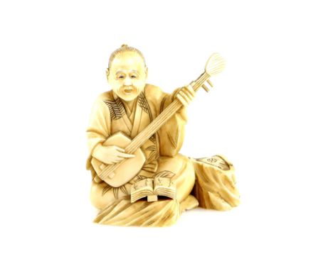 A sectional, ivory okimono carved as a seated Samisen player, 6.5 cm high, 19th or 20th CenturyProvenance: The Property of a 