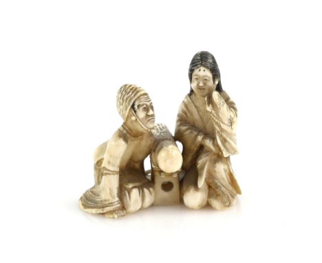 A stained ivory okimono of a man and women beside a large club, 5 cm high, 20th CenturyProvenance: The Property of a Lady. Fr