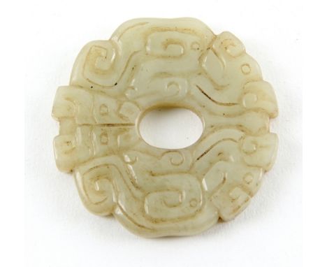 A Chinese green jade disc carved with stylised dragons, 4.5cm diameter, post Qing Dynasty    .