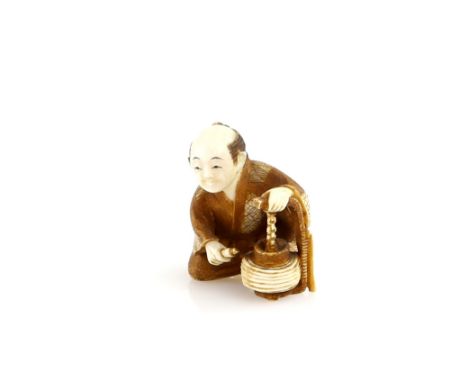 A stained ivory netsuke carved as a seated Lantern Maker, signed Kogyoku, 20th CenturyProvenance: The Property of a Lady. Fro