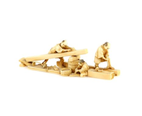 A stained ivory okimono designed as a group of three wood workers; 13.5 cm long, Meiji PeriodProvenance: The Property of a La
