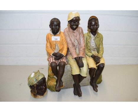CERAMIC MODEL OF THREE FIGURES SAT ON A WALL, TOGETHER WITH A FURTHER CERAMIC TOBACCO JAR FORMED AS A HEAD (2)
