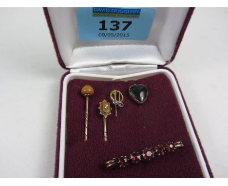 Four Victorian and later stick pins and a brooch (tested for gold)