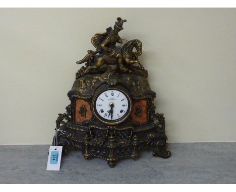 Cast brass mantle clock surmounted by equestrian figure, striking the half hour on two bells