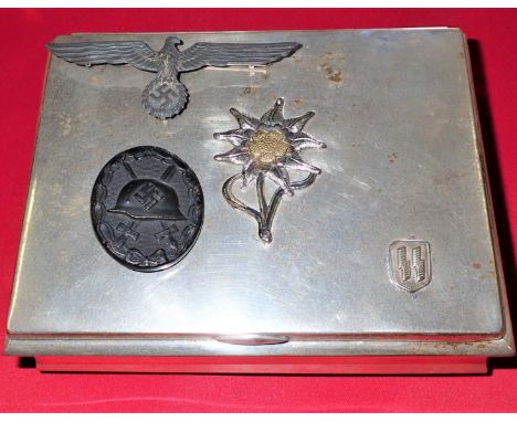 German silver-plated jewellery box, with edelweiss and SS runes affixed to top lid. Wooden interior, showing central crack li