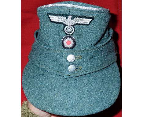 WW2 M43 German Army officer’s uniform field cap. Field grey wool body peak and fold down flaps, retaining both silver washed 