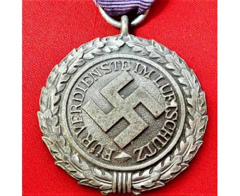 WW2 German Luftschutz Medal. Aluminium medal, with some light silver frosting to sharp details. Light spotting to reverse.