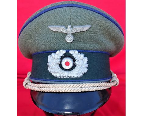 WW2 German Army Medical officer’s peaked cap. Good black leather peak, field grey wool twill crown, dark blue piped and green