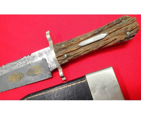 1950’s era IXL Bowie knife and scabbard with gilt silver engraving to c19th blade. Features coffin handle with stag grip scal