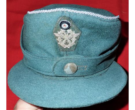 WW2 M43 German ‘Mountain’ Police officer’s uniform field cap. Blue grey wool body peak and fold down flaps, retaining single 