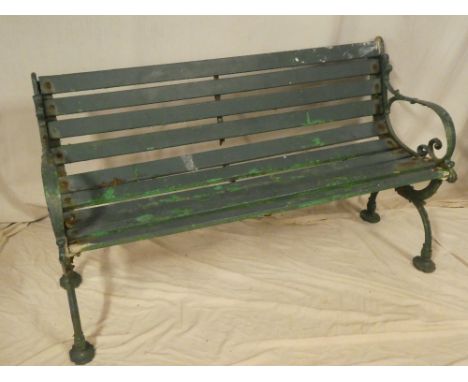 A Victorian cast iron garden bench with scroll ends and wooden slats (af), 51" long