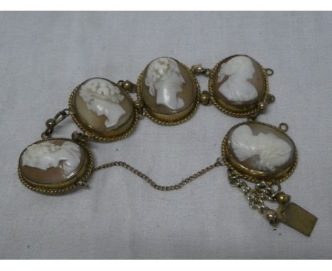 A gilt ornamental bracelet mounted with five cameo female portrait panels