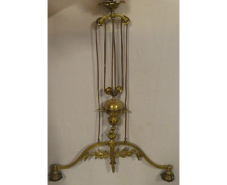 An ornate brass hanging rise-and-fall twin branch light fitting with raised leaf decoration and attached weight