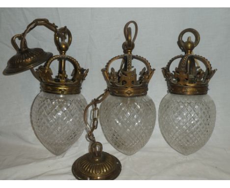 Three matching brass hanging light shades with coronet tops and cut glass shades, 13" long overall