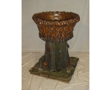 An unusual 19th Century salt glazed garden urn and stand modelled as a tree trunk, the top 25" diameter, 31" high on square c