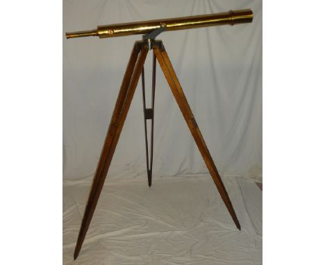 A good quality brass telescope with presentation plaque dated 1978, 53" long on brass and iron mounted mahogany tripod