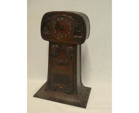 An unusual Art Deco copper cased mantel clock decorated in relief with stylized flowers, birds and emblems "Time Flies I Mark