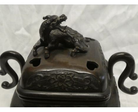 A 19th Century Japanese bronze square two handled koro and cover with raised floral decoration and dragon finial, 11" high