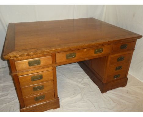 A good quality reproduction polished wood rectangular partner's desk with three drawers in the frieze, slides and six pedesta