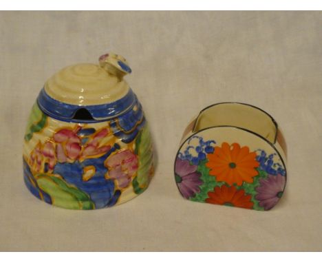 A Clarice Cliff Bizarre "Beehive" pattern preserve jar and cover with painted floral decoration and a Clarice Cliff Bizarre "