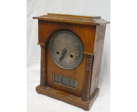 A 1930s Art Deco-style mantel clock with pewter circular dial in polished oak rectangular case
