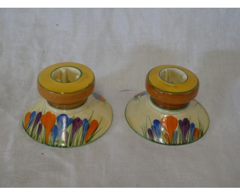 A pair of Clarice Cliff  Bizarre "Crocus" pattern squat-shaped candlesticks, 2" high (one af)