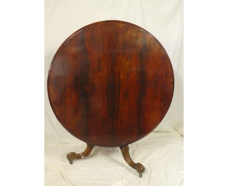 A Victorian rosewood circular turnover top breakfast table on octagonal tapered column and tripod scroll base, 50" diameter