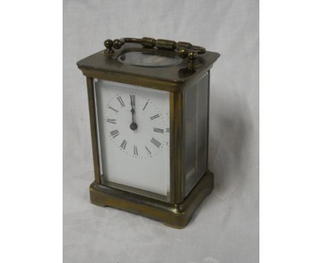 A Continental carriage clock with rectangular enamelled dial in brass traditional glazed case
