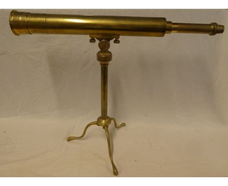 An old brass telescope, 26" long on adjustable brass table stand with tripod base
