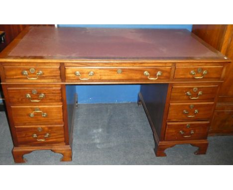 A polished mahogany rectangular pedestal desk with three drawers in the frieze and six pedestal drawers on bracket feet