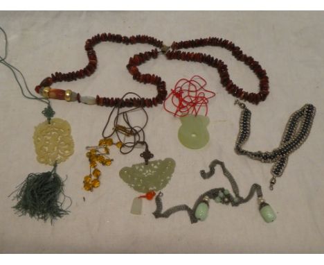 A selection of various costume jewellery including beadwork necklaces, jade pendants, etc