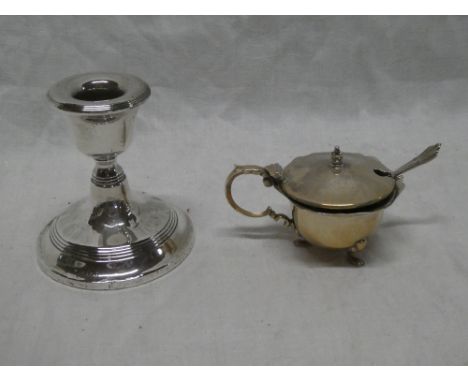 A small silver squat-shaped table candlestick with circular spreading base, Birmingham marks and a silver circular mustard po