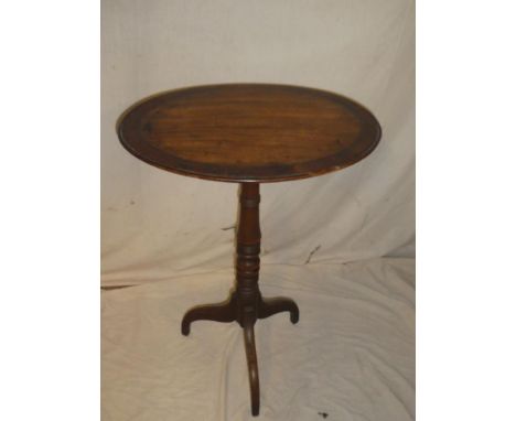 A 19th Century mahogany cross-banded oval occasional table on turned column tripod base